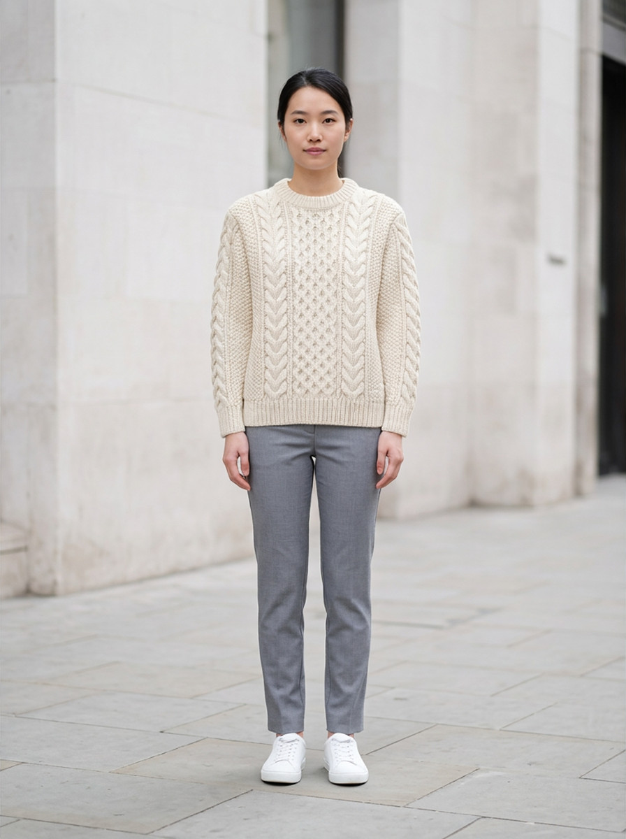 Cream chunky cable knit sweater, front view, outdoor daylight street