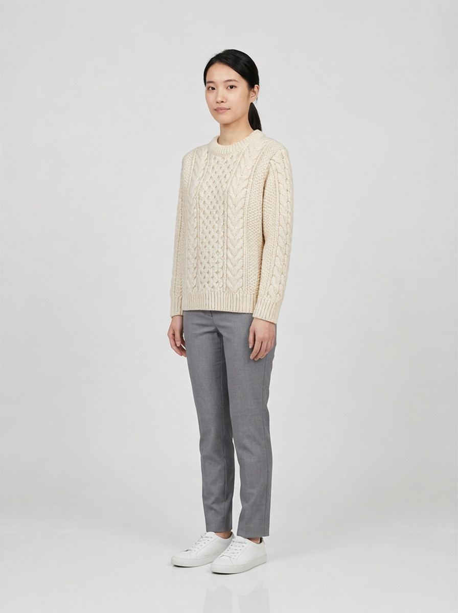 Cream chunky cable knit sweater, three-quarter view, studio packshot