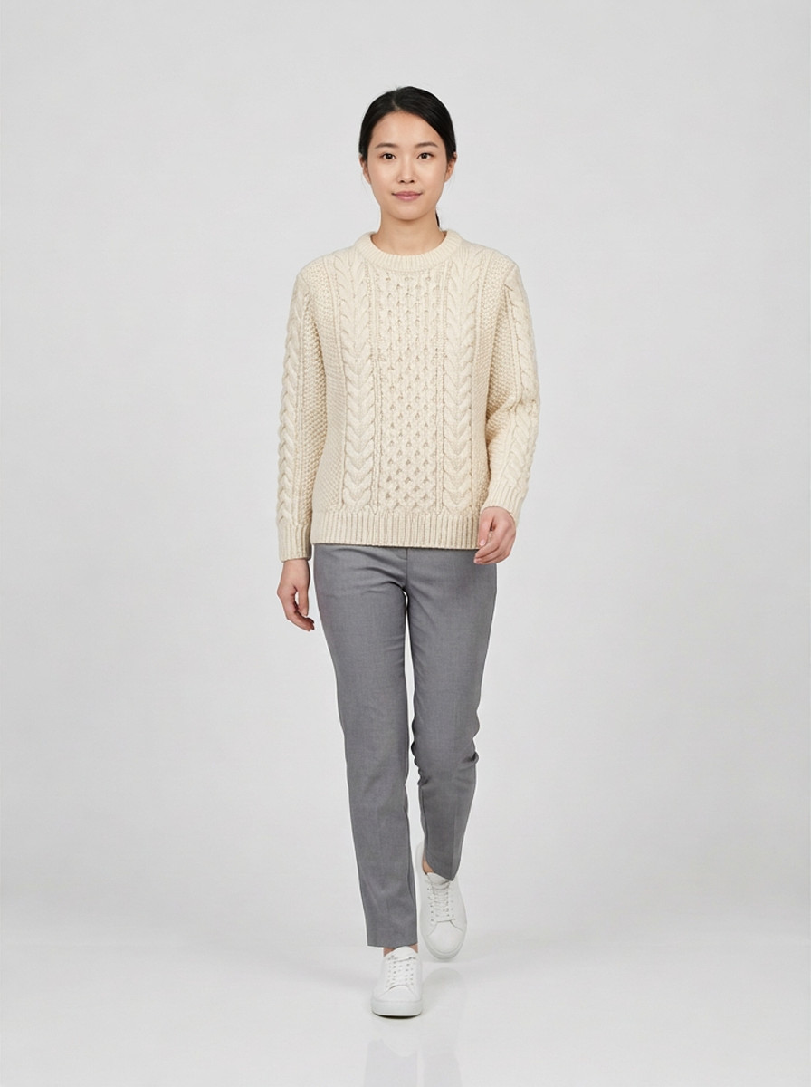 Cream chunky cable knit sweater, walking, studio packshot