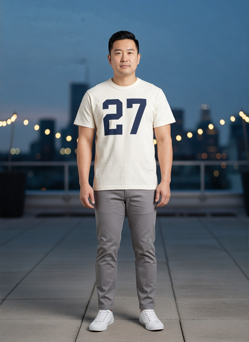Off-white tee with a navy varsity number 27, front view, blue-hour rooftop event